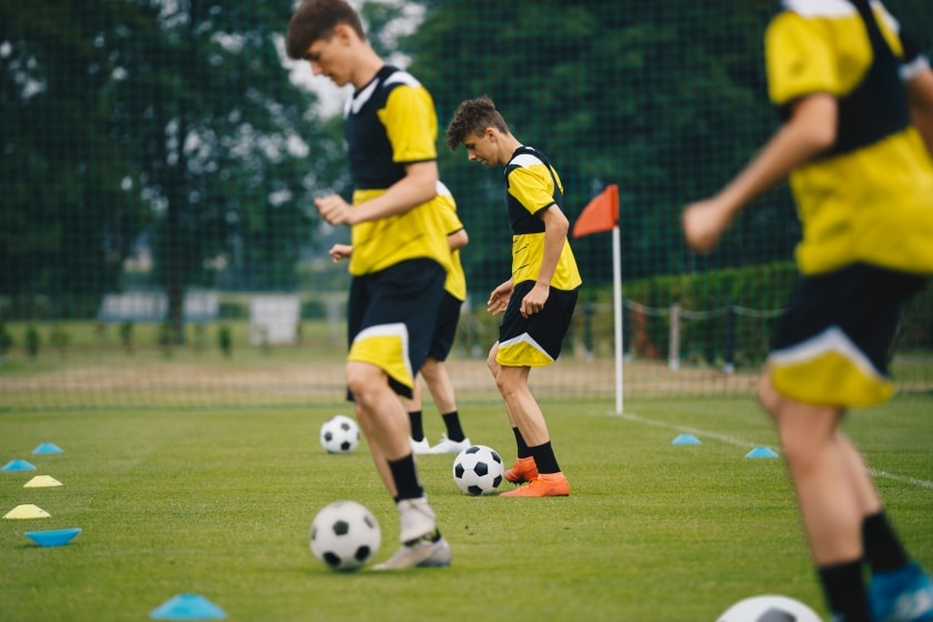 Young soccer players doing training drills
