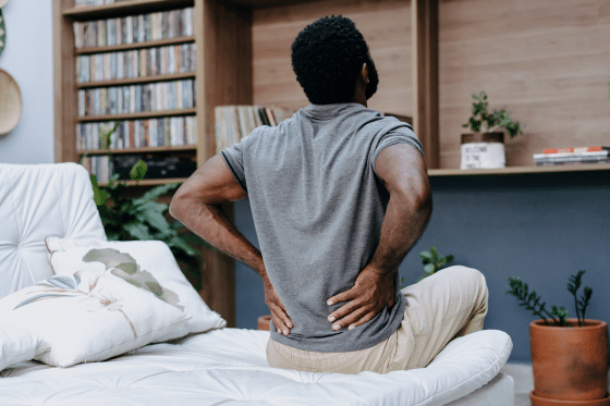 A man struggles with back pain in his daily life